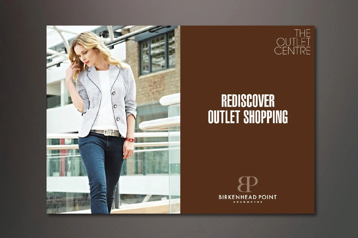 Rediscover outlet shopping advertisement with the Birkenhead Point logo on brown